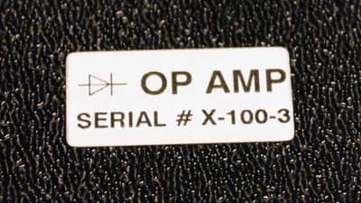 Girintili çıkıntılı bir yüzeye sağlam bir şekilde uygulanmış Brady ultra-kuvvetli yapışkanlı çok amaçlı etiket.